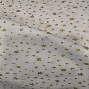 Tela con estrellas salteadas  en color oro sobre blanco